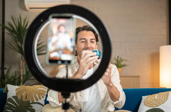 Man creating online content about beauty products at home for social media