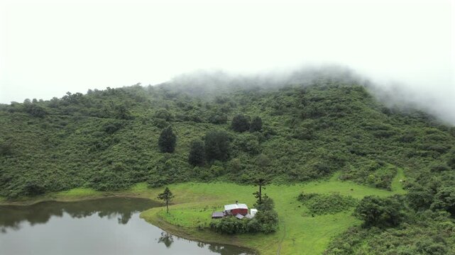 4K drone aerial view of Yala Provincial Park in Jujuy, Argentina. Misty mountain lakes surrounded by lush Yungas forests and dense green vegetation in a spectacular Andean landscape.