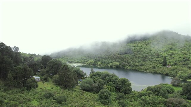 4K drone aerial view of Yala Provincial Park in Jujuy, Argentina. Misty mountain lakes surrounded by lush Yungas forests and dense green vegetation in a spectacular Andean landscape.