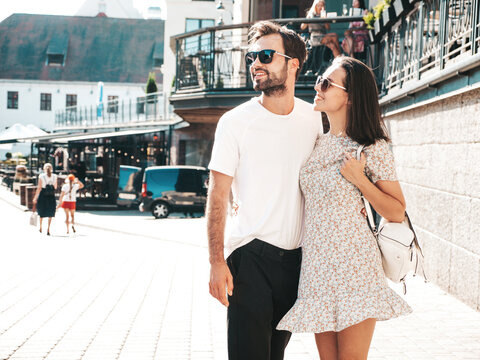 Smiling beautiful woman and her handsome boyfriend. Woman in casual summer clothes. Happy cheerful family. Female having fun. Couple posing on the street background