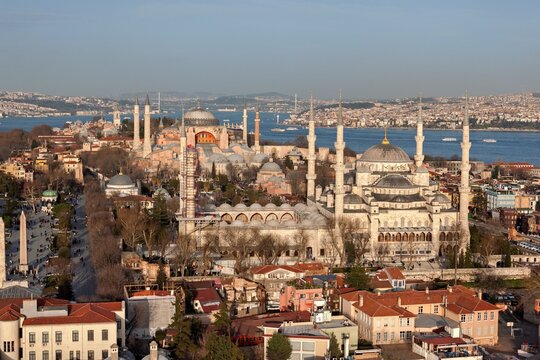 Aerial view of Sultanahmet Square featuring the Blue Mosque and Hagia Sophia with the Bosphorus in the background in Fatih, Istanbul, Turkey.