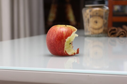 a bitten apple on a table