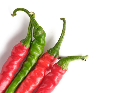 Studio shot green and red chili peppers on white background.