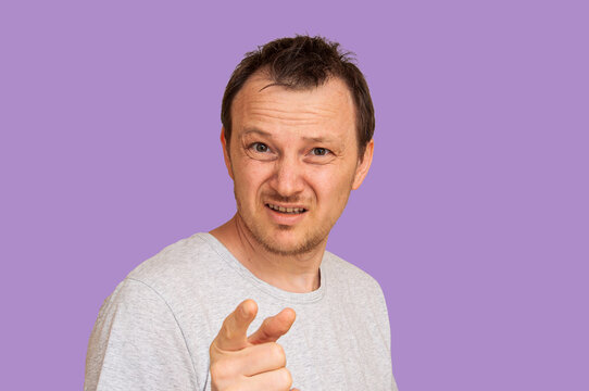 Man pointing finger accusingly with a skeptical expression on his face