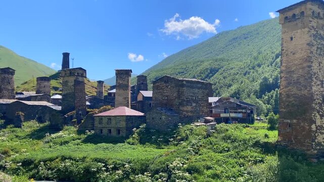 Svan towers rising wide view above Ushguli village in Svaneti, Georgia, showing medieval defensive architecture, cultural heritage, mountain settlement history, and destination tourism in the Caucasus