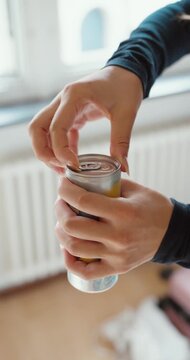 Close-up of a woman struggling to open a beverage can with her fingernails, representing everyday frustration, difficult packaging, and opening problems.
