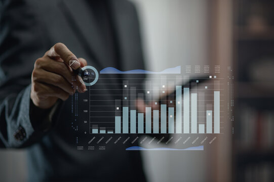Businessman Analyzing Financial Data with Digital Graphs and Charts