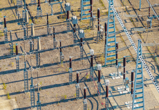 Aerial view of a high voltage electrical substation featuring switchgear, busbars, circuit breakers, and power distribution grid infrastructure in Saulce-sur-Rhone, Auvergne-Rhone-Alpes, France.