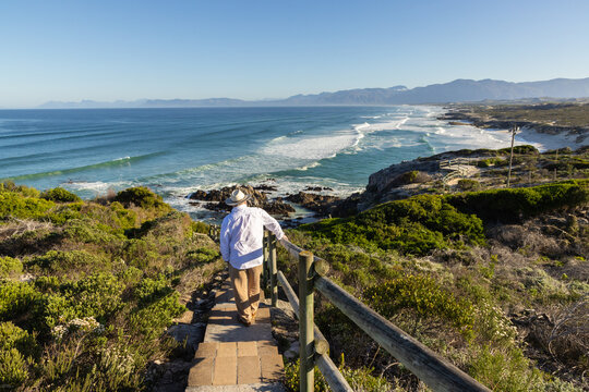 adult man wearing hat exploring beautiful Walker Bay Nature Reserve, Gansbaai, South Africa