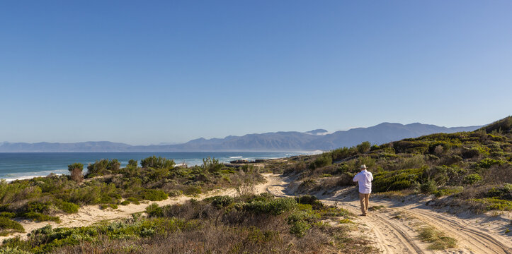 adult man wearing hat exploring beautiful Walker Bay Nature Reserve, Gansbaai, South Africa