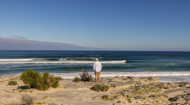adult man wearing hat exploring beautiful Walker Bay Nature Reserve, Gansbaai, South Africa