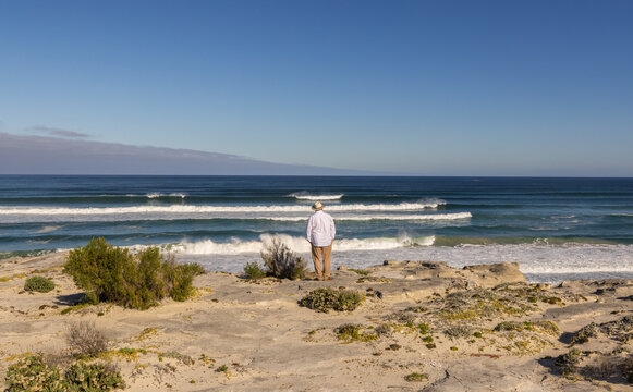 adult man wearing hat exploring beautiful Walker Bay Nature Reserve, Gansbaai, South Africa