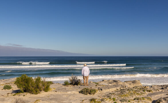 adult man wearing hat exploring beautiful Walker Bay Nature Reserve, Gansbaai, South Africa