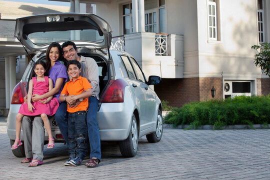 Family sitting at the back of a car