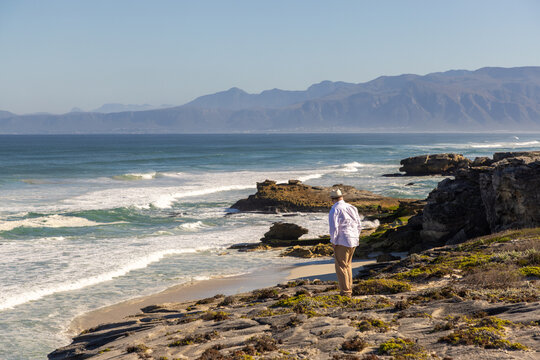 adult man wearing hat exploring beautiful Walker Bay Nature Reserve, Gansbaai, South Africa