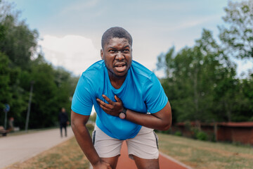 Fototapeta premium Man having chest pain during outdoor running workout