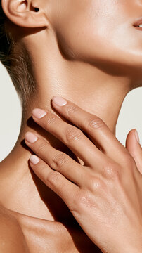 Hands gently massage the neck and jawline in a lymphatic drainage ritual, closeup skin texture. A calm beauty routine promoting glow and relaxation.