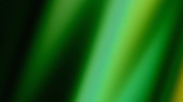 Abstract grainy background with green and yellow gradient light effect