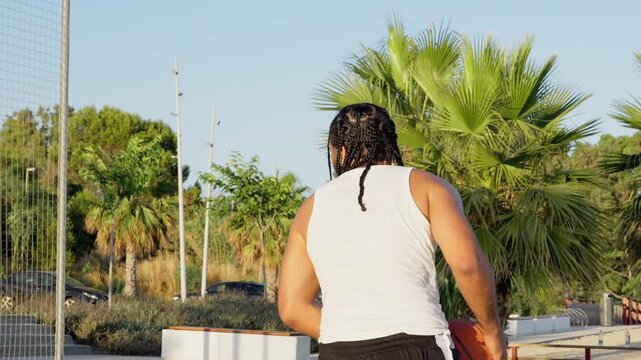 Streetball player making a successful jump shot outdoors