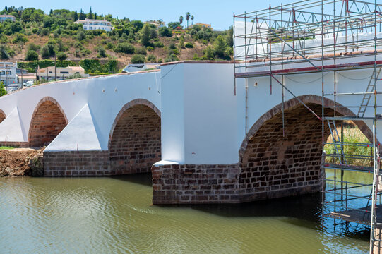 Ancient magnificent architecture Roman bridge in final stages of restoration in idyllic Algarve Portugal town