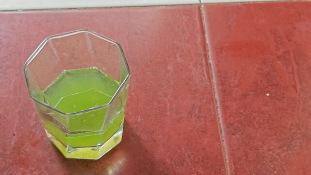 Adding Dropper Drops of Turpentine Oil into Glass with Green Liquid