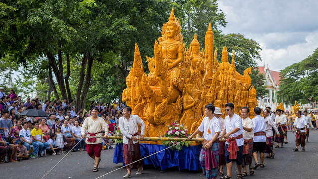 Ubon candle festival procession with carved wax float and community helpers