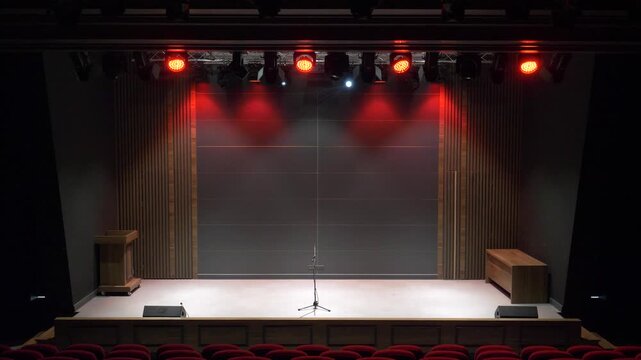 An footage of an empty stage where activities such as music, concerts, and theater presentations will take place. An indoor hall equipped with professional sound and light systems.