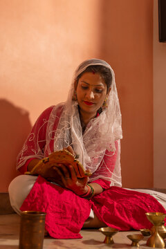 Woman preparing ritual items with devotion