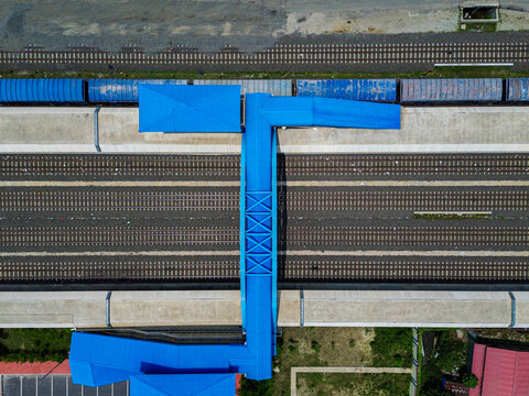 Aerial view of Soydabad Railway Station Jame Mosque featuring a prominent blue roof and pedestrian bridge over railway tracks in Sirajganj, Rajshahi Division, Bangladesh.