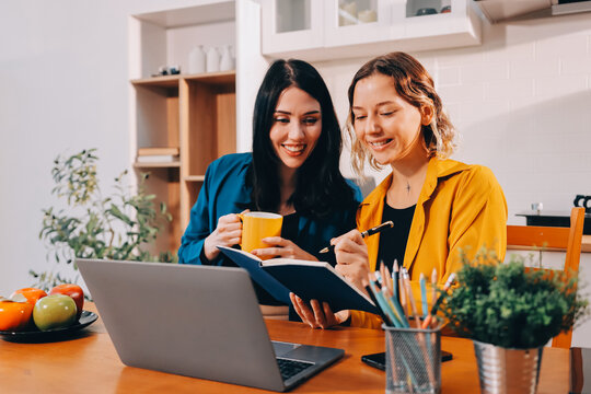 Portrait of military mother helping teen daughter with homework and eating lunch