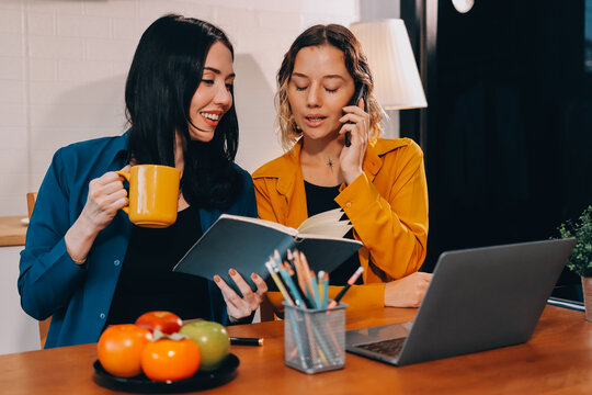 Portrait of military mother helping teen daughter with homework and eating lunch