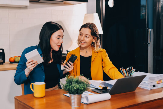 Portrait of military mother helping teen daughter with homework and eating lunch