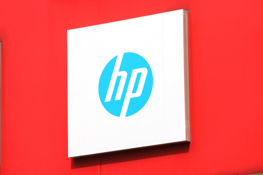 A close-up angled view of the minimalist HP corporate logo and sign on a vibrant red wall, Ho Chi Minh City, Vietnam - February 7, 2026.