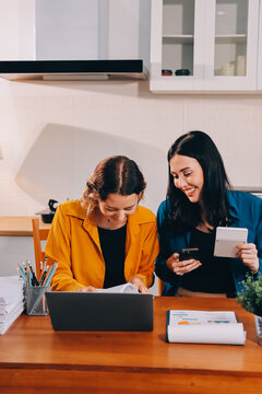 Portrait of military mother helping teen daughter with homework and eating lunch