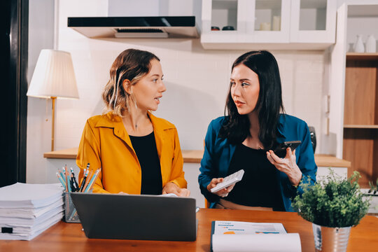 Portrait of military mother helping teen daughter with homework and eating lunch