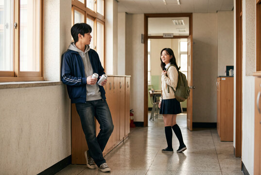 Teen students in a high school hallway candid moment between classmates for education poster background and campus lifestyle design