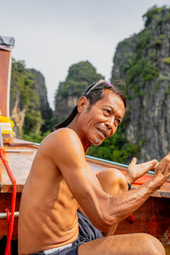 Thai man longtail boat captain working in thailand