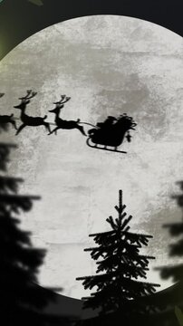 Yellow christmas string lights flashing over trees and santa passing full moon in sleigh