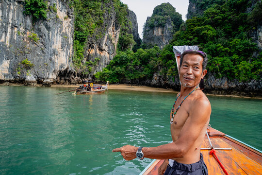 Thai man pointing navigating through phang nga bay