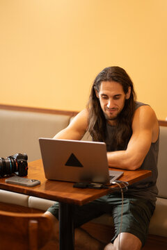 Creative professional man working remotely on laptop at cafe