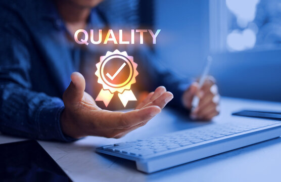 The quality concept with a businessman holding a quality icon, represents need for quality at every stage of the business, from internal operations to delivery and customer care