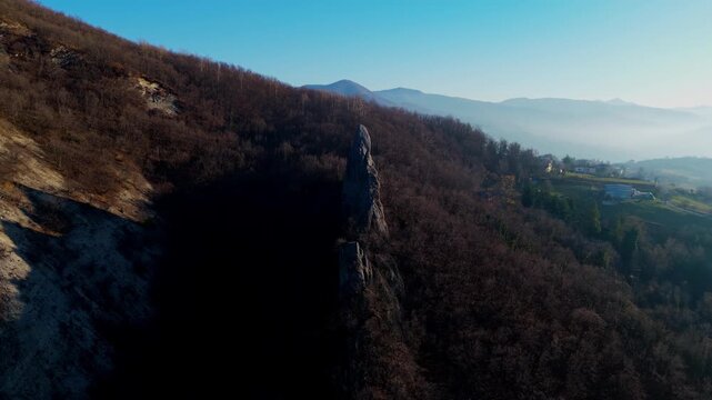 A cinematic aerial shot showcasing the unique Salti del Diavolo rock spires in the Italian Apennines during golden hour. Perfect for travel documentaries and environmental storytelling.