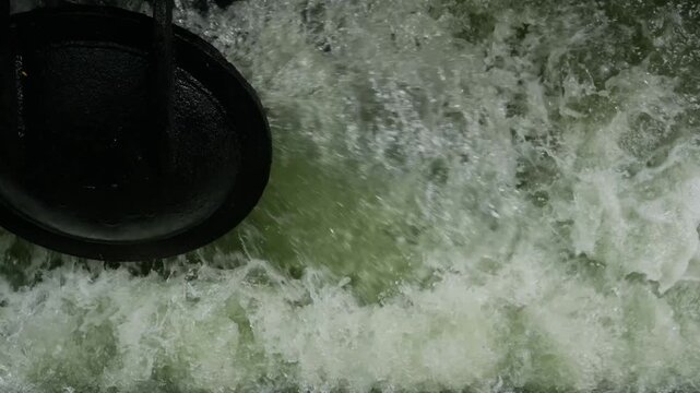 Iron Sluice Valve with Powerful Green Water Splash Close-Up