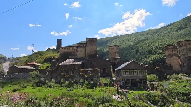 Svan towers overlook Ushguli, wide view across the historic mountain settlement in Georgia, supporting cultural tourism, architectural heritage, preservation and regional destination promotion