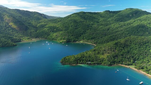 Aerial view of the calm and green lagoon with sailing boats on the island of Ilha Grande, Brazil