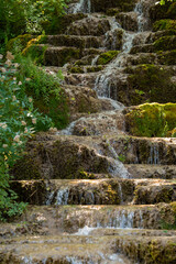 Water trickling over natural green mossy tufa rock cascades and travertine terraces at Bigar Waterfall near Kalna village at Stara Planina nature reserve in Serbia. © Dragan