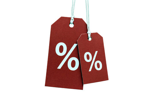 Two red percentage discount tags hanging by strings ready for sale promotion and advertising