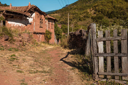 Authentic old abandoned mud and stone house with a partially collapsed roof showcasing traditional Balkan vernacular architecture at Topli Do village in Stara Planina, Serbia.