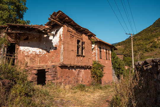 Authentic old abandoned mud and stone house with a partially collapsed roof showcasing traditional Balkan vernacular architecture at Topli Do village in Stara Planina, Serbia.