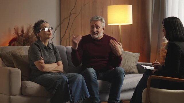 Displeased man in his 50s complains about wife during couples therapy session